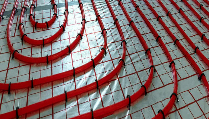 Which pipe is ideal for radiant floor heating because it can bend into loops?