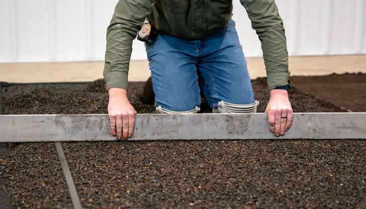Which tool is used to level freshly poured concrete?