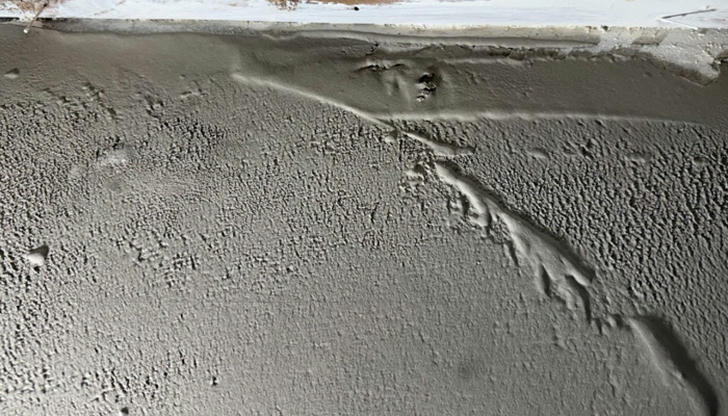 What usually causes an uneven concrete surface?