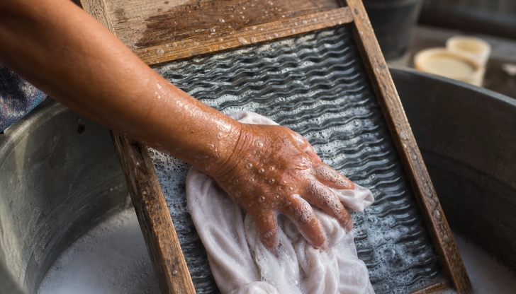What corrugated metal tool inside a wooden frame was used to scrub clothes in a tub of soapy water?