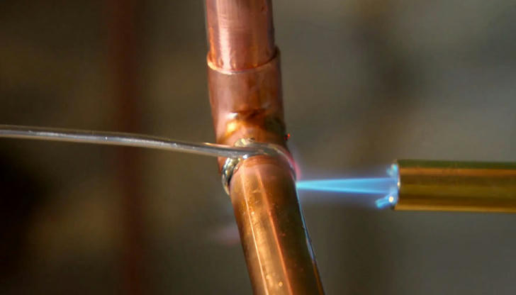 In plumbing, what does the term "sweating" mean?