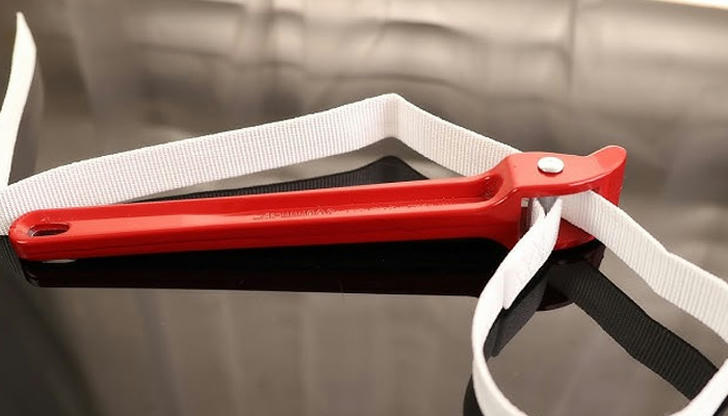 Which tool grips round fittings without damage?