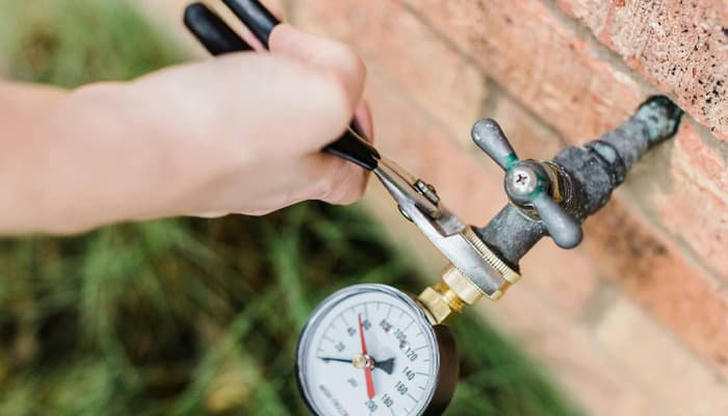 Which tool measures water pressure in a system?