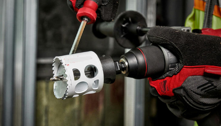 Which tool drills circular holes through wood for pipes?
