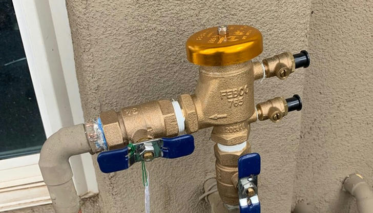 In plumbing, what does a vacuum breaker do?