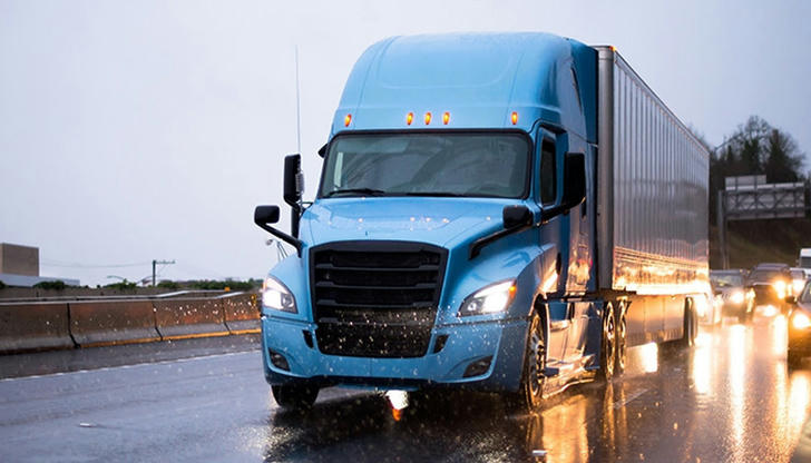 What should you do if your brakes get wet after driving through deep water?
