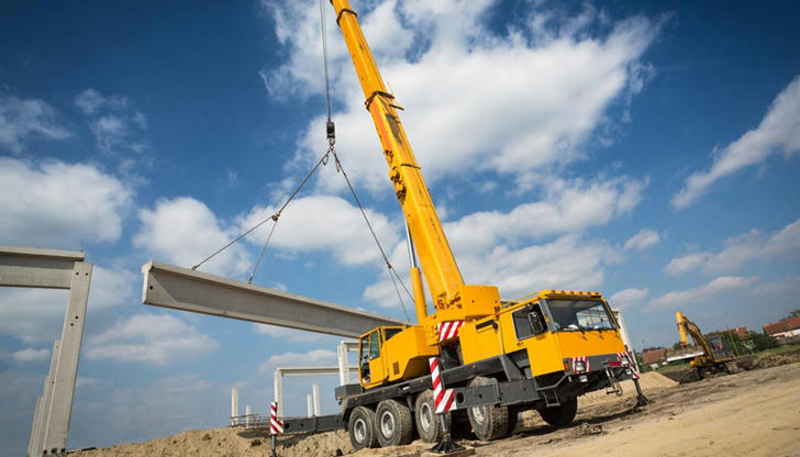 A crane on a construction site is used to ______.