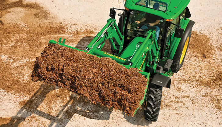 On a loader, what is the front bucket designed to do?