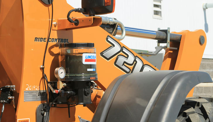 On a loader, which part should be lubricated regularly to ensure smooth movement?