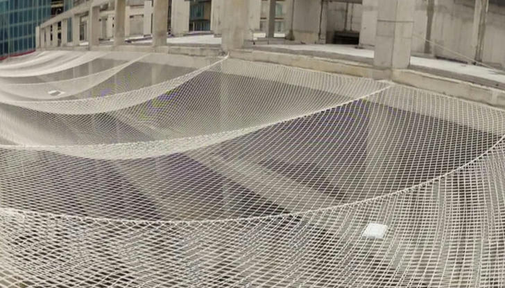 Which safety system catches workers or debris falling from above?