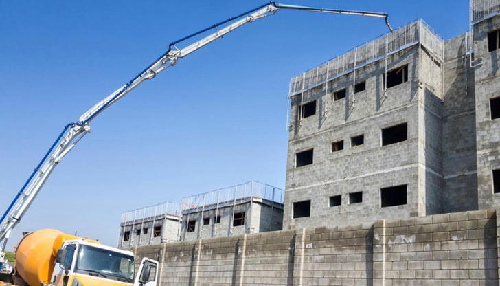 Which equipment moves liquid concrete to areas trucks cannot reach?