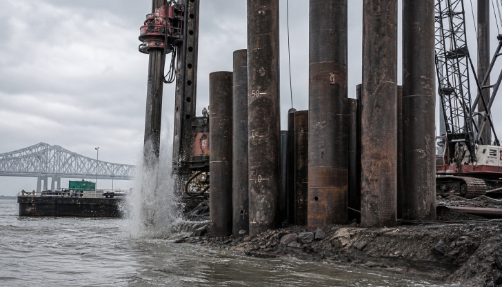 Which heavy machinery is designed to drive long steel, wood, or concrete piles deep into the soil to provide foundation support for bridges and buildings?