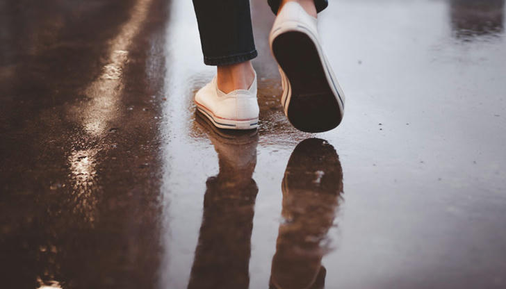 When concrete looks dry, what sign suggests it may handle walking?