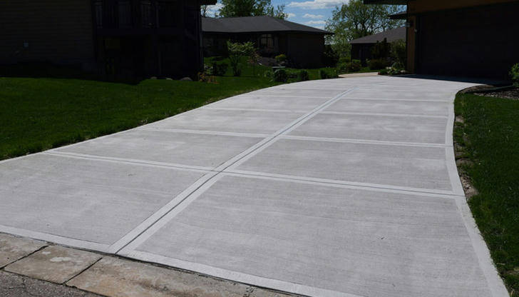 If a driveway feels dry, when is it safer to drive on it?