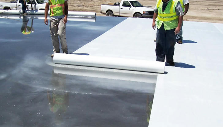 If new concrete is covered to slow moisture loss, what should be used?