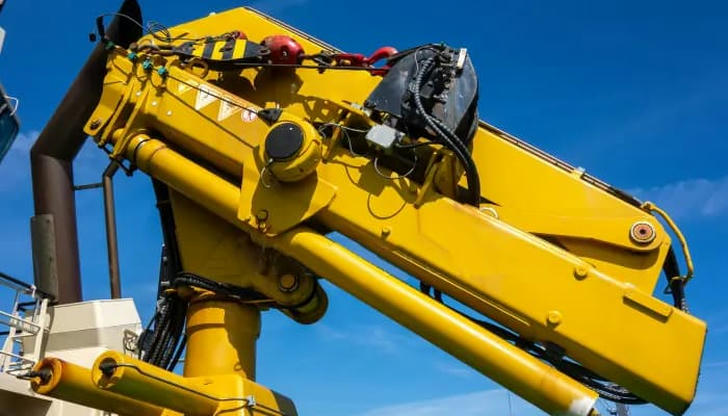 What does the hydraulic system in an excavator control?