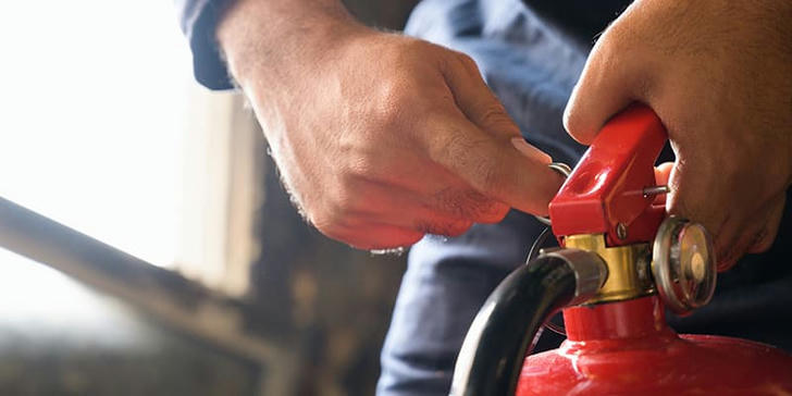 What is the standard 'PASS' technique for fire extinguisher use?