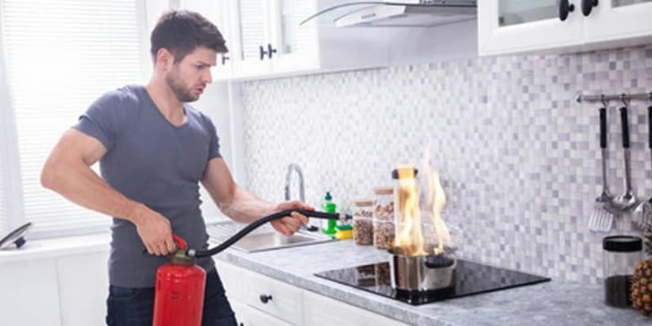 Which common household item can be used as an emergency fire suppression tool?
