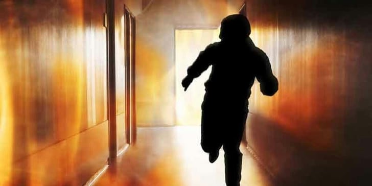 Which action should be avoided during a fire evacuation?