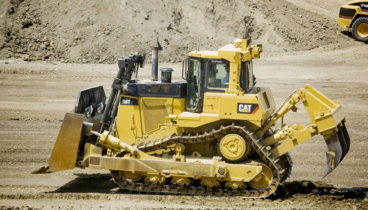 Which machine is mainly used to push large amounts of soil forward?