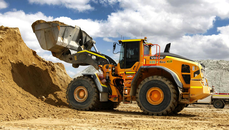 Which machine is best suited for repeatedly loading loose material into trucks?