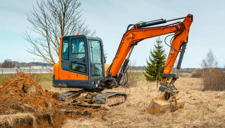 A tight residential backyard job usually calls for which machine?