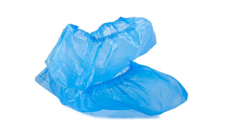 Which disposable item is worn over shoes to maintain hygiene in sterile areas?