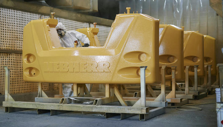 Which component stabilizes the loader when lifting heavy loads?