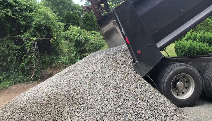 Which material is a dump truck most commonly used to carry?