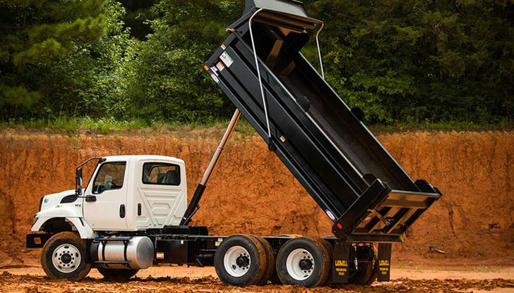 When is a dump truck more likely to become unstable?