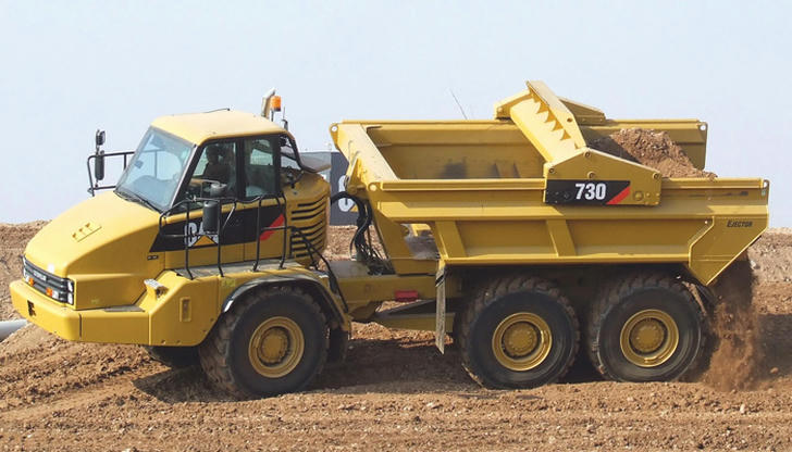 What condition increases tipping risk when a dump truck unloads?