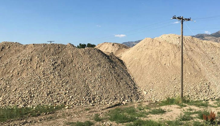 Which area is most likely used for temporary dumping of soil or gravel?