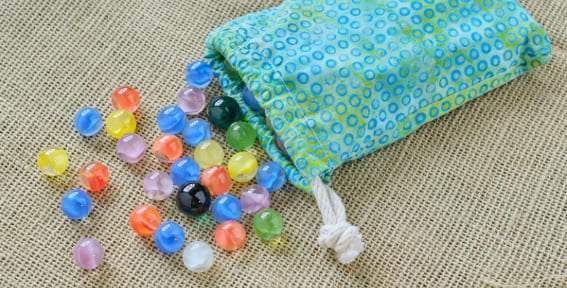 Liza, Isabella, and Kyle decide to split a bag of marbles. Liza takes half of the total. Isabella then takes a third of the remaining marbles. Kyle takes the last 20 marbles. How many marbles were in the bag initially?