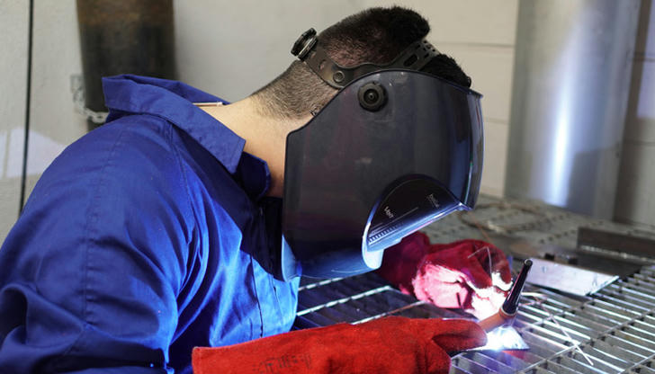 Which safety gear protects a welder’s eyes from bright welding light?