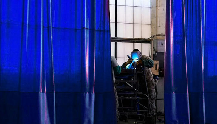 What is the purpose of welding curtains in a workshop?