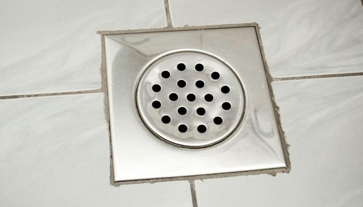 Identify this round plumbing item used for removing water from a basement floor.