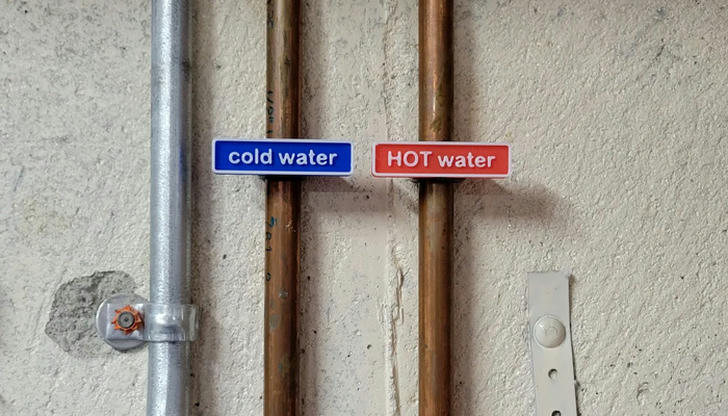What does this red "HOT WATER" label indicate?