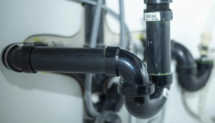 If a sink drains slowly, what is the first thing to check?