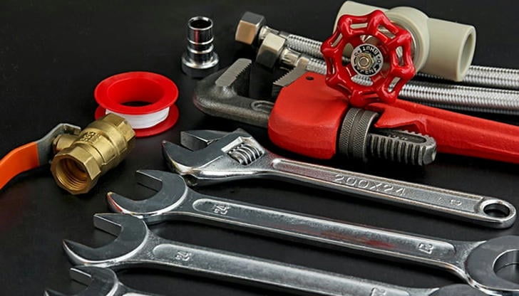 What is the safest way to handle plumbing tools?