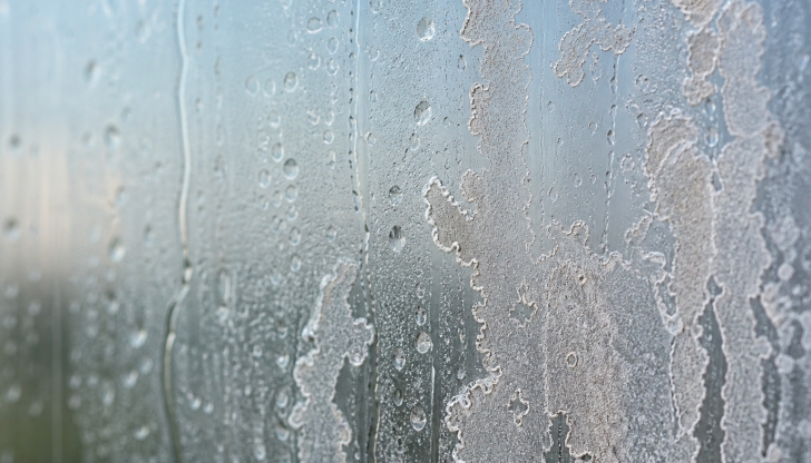 What 10-second habit prevents hard water spots and soap scum from bonding to glass shower doors?