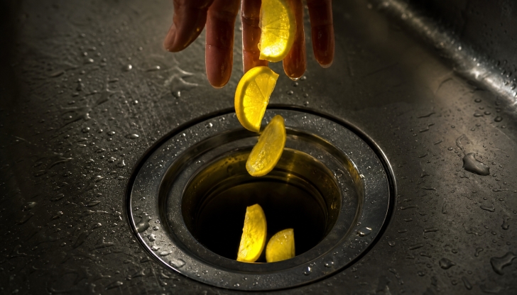 What classic kitchen trick cleans and sharpens garbage disposal blades while removing bad odors?