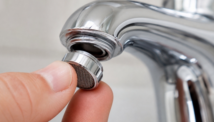 What tiny mesh circular screen screws onto the very tip of faucet nozzles to blend air with the running water stream?