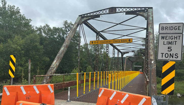13. What should you do when you see a "weight limit" sign on a bridge?