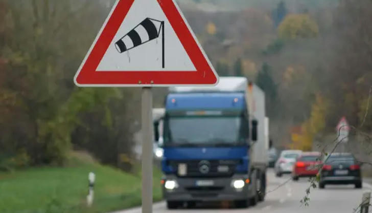 24. When driving in strong crosswinds, what should a driver do?
